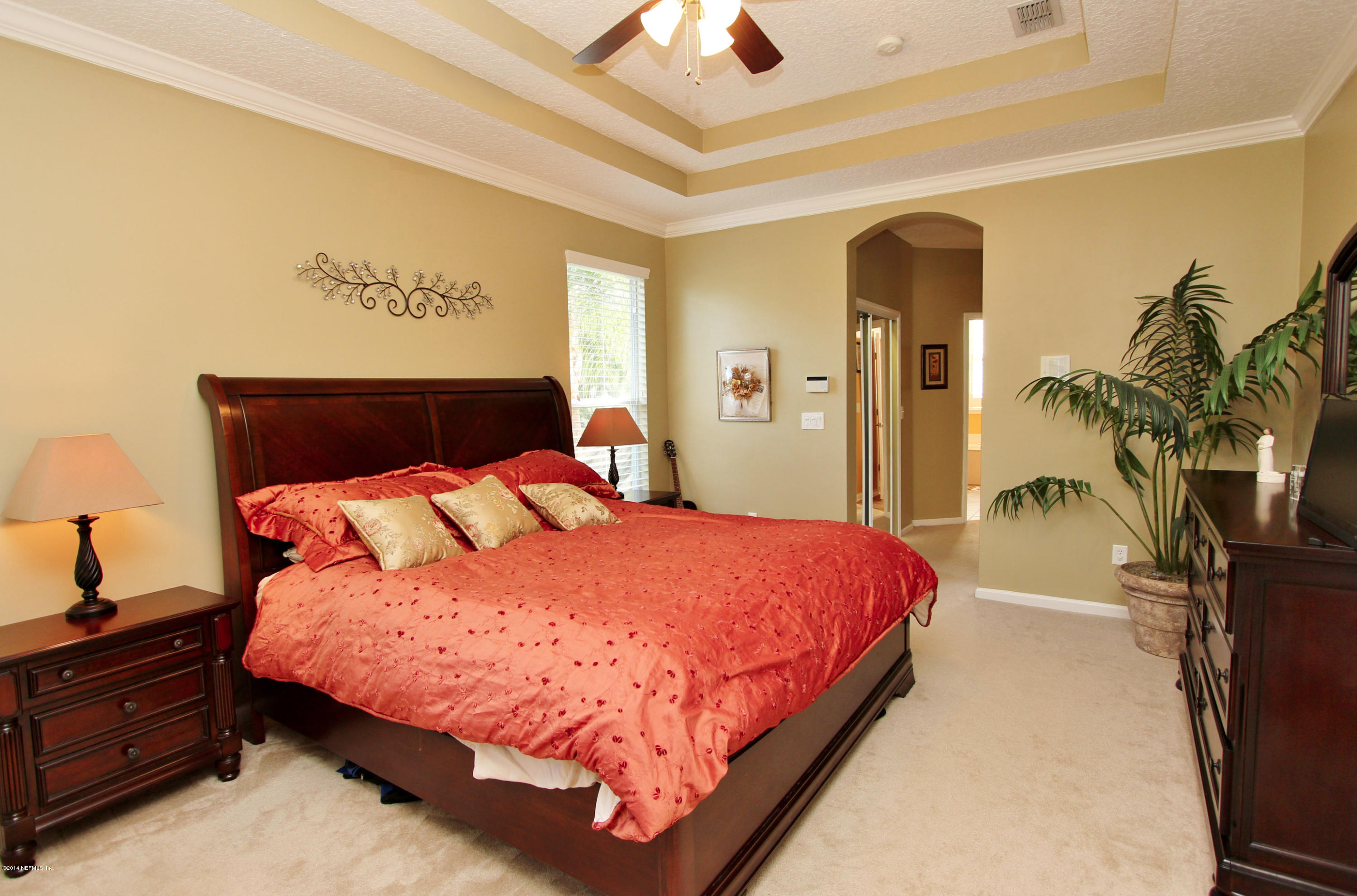 2001 River's Own Road St. Augustine, FL 32092 - Photo 7 of 55 a bedroom with a bed and a chandelier