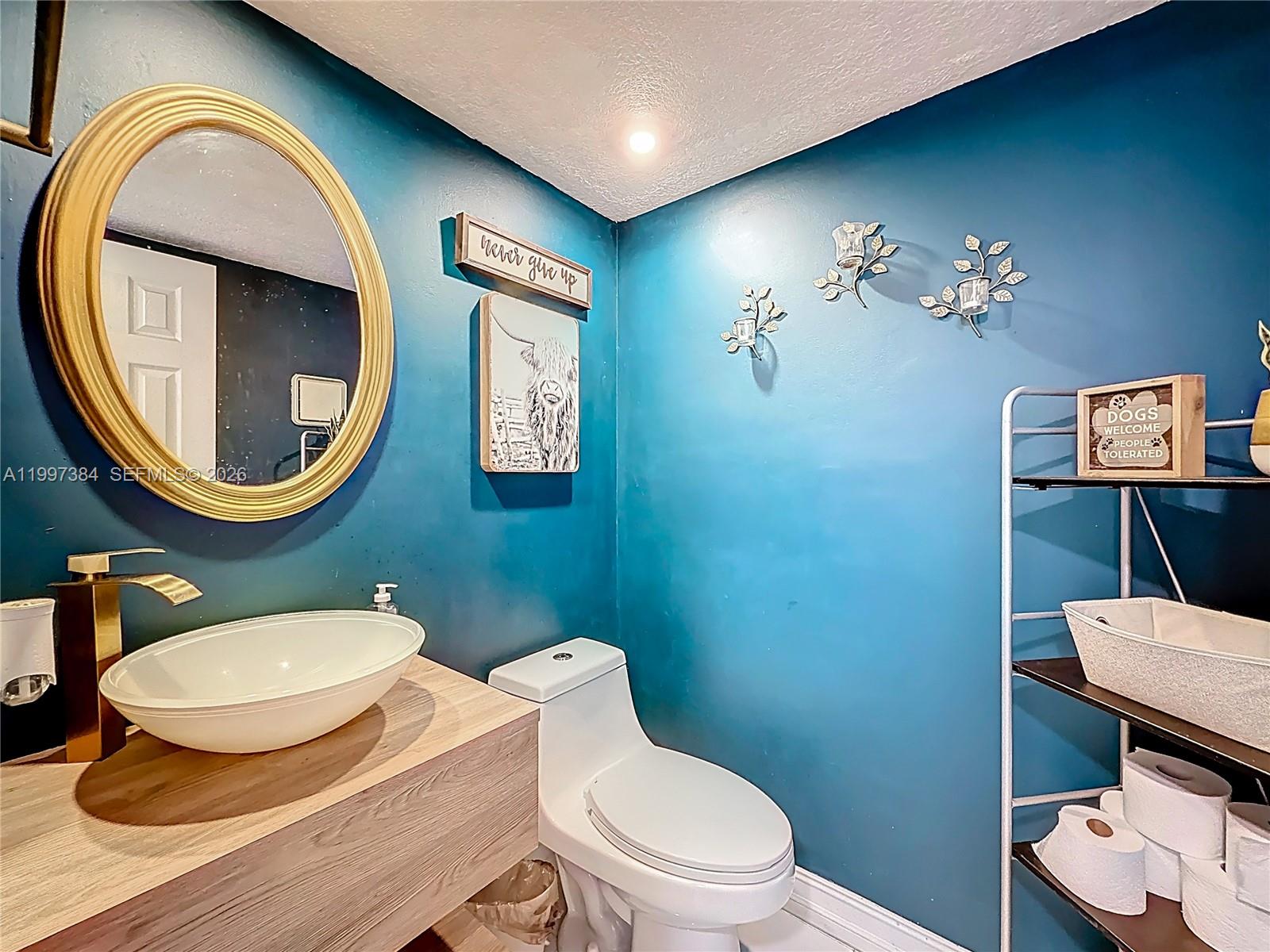 1291 Southwest 124th Court, Unit 19B Miami, FL 33184 - Photo 16 of 33 a bathroom with a toilet a sink and a mirror