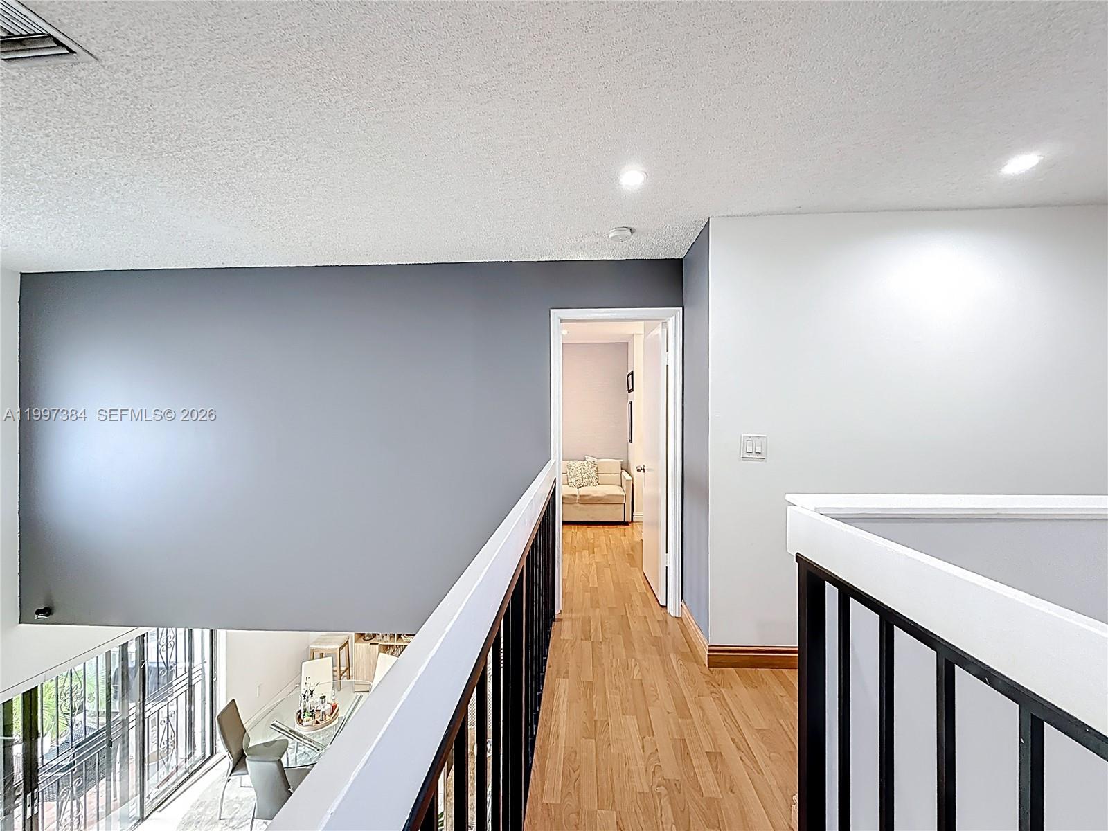 1291 Southwest 124th Court, Unit 19B Miami, FL 33184 - Photo 17 of 33 a view of a hallway with wooden floor