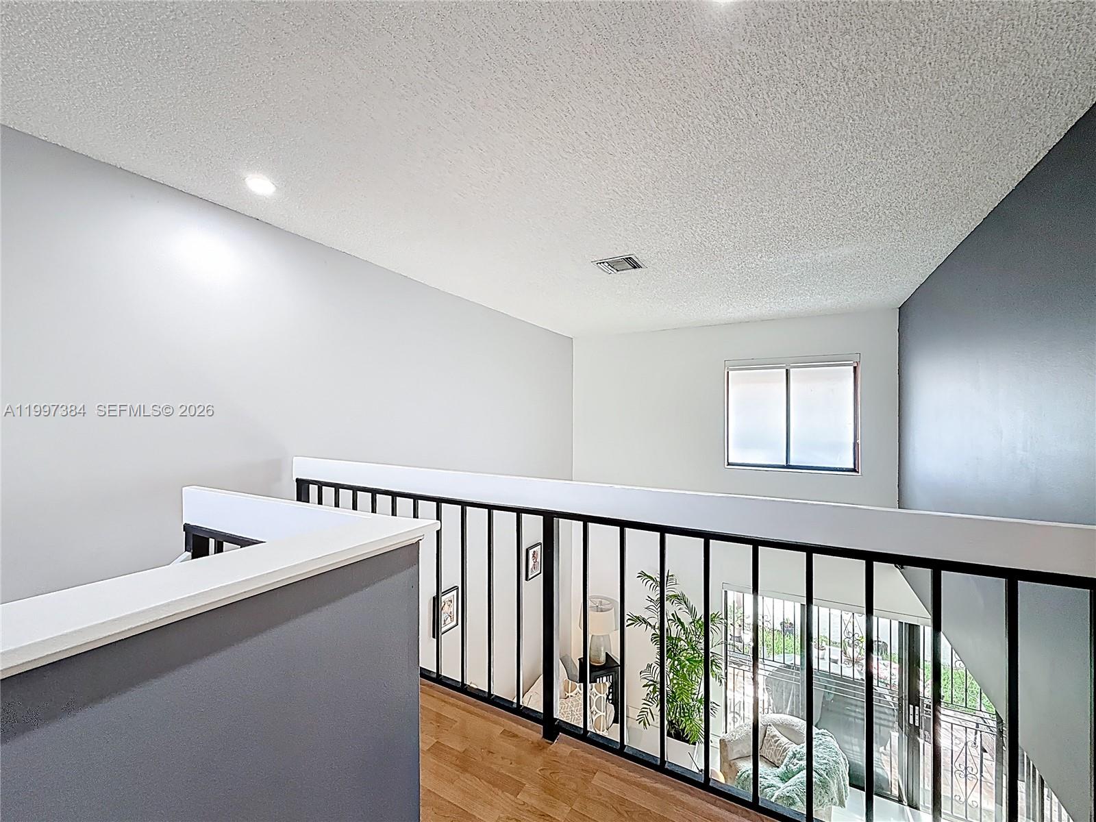 1291 Southwest 124th Court, Unit 19B Miami, FL 33184 - Photo 18 of 33 a view of a hallway with windows