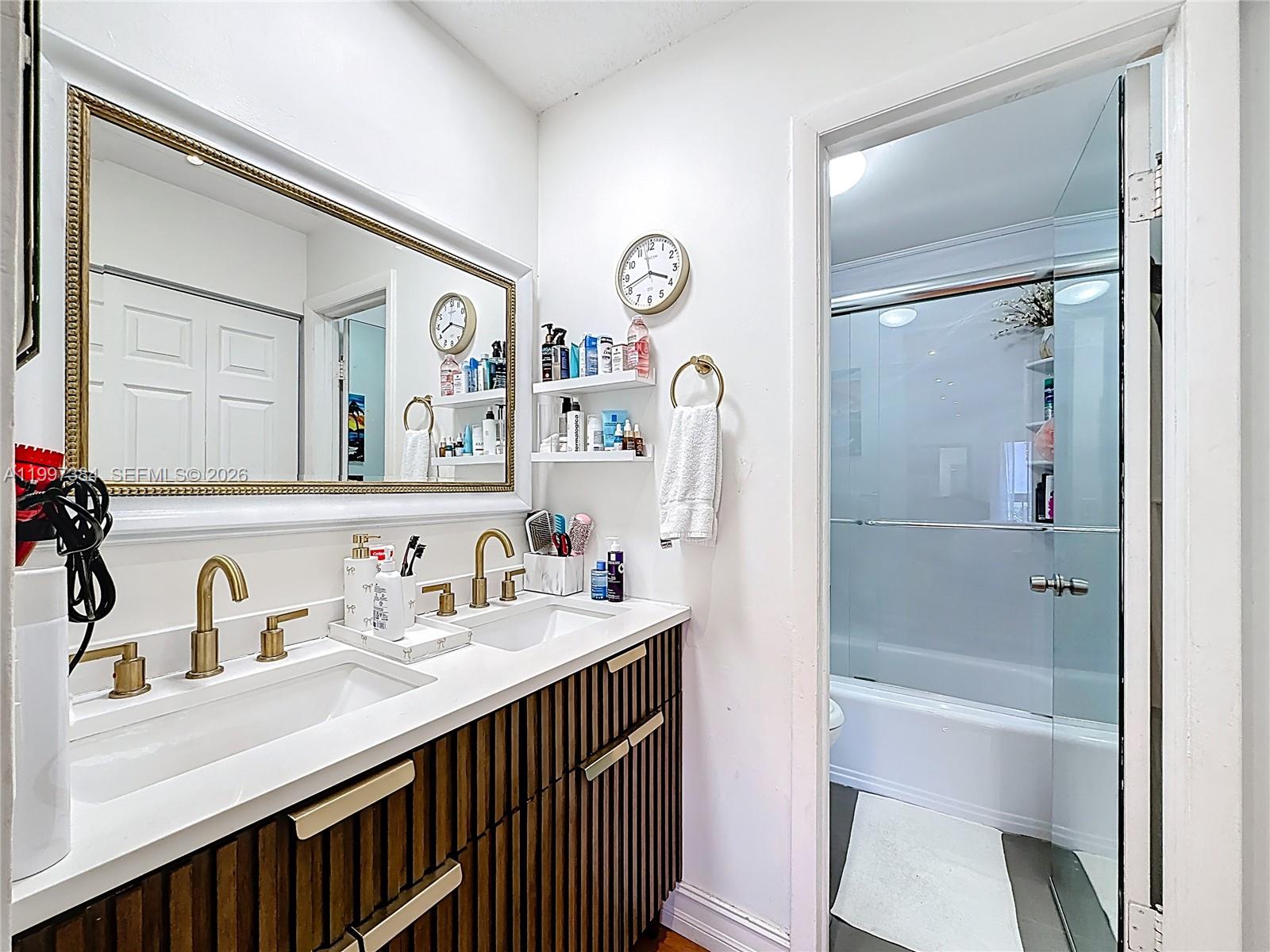 1291 Southwest 124th Court, Unit 19B Miami, FL 33184 - Photo 22 of 33 a bathroom with a sink a toilet and shower