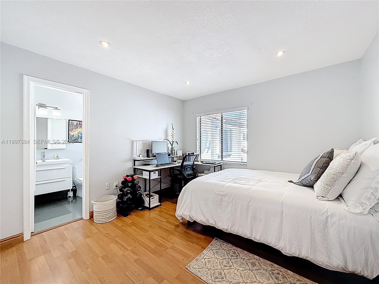 1291 Southwest 124th Court, Unit 19B Miami, FL 33184 - Photo 24 of 33 a bedroom with a bed and a view of bedroom