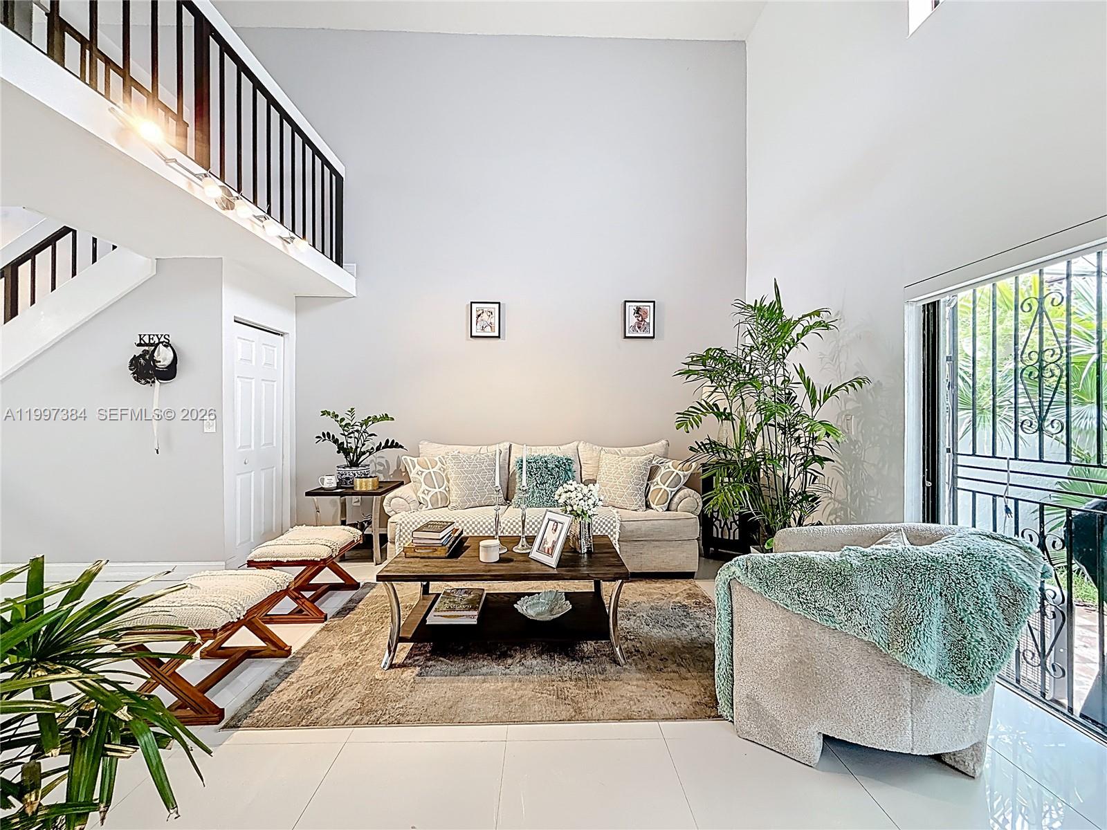 1291 Southwest 124th Court, Unit 19B Miami, FL 33184 - Photo 7 of 33 a living room with furniture and a potted plant