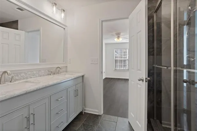 a bathroom with a granite countertop sink and a mirror