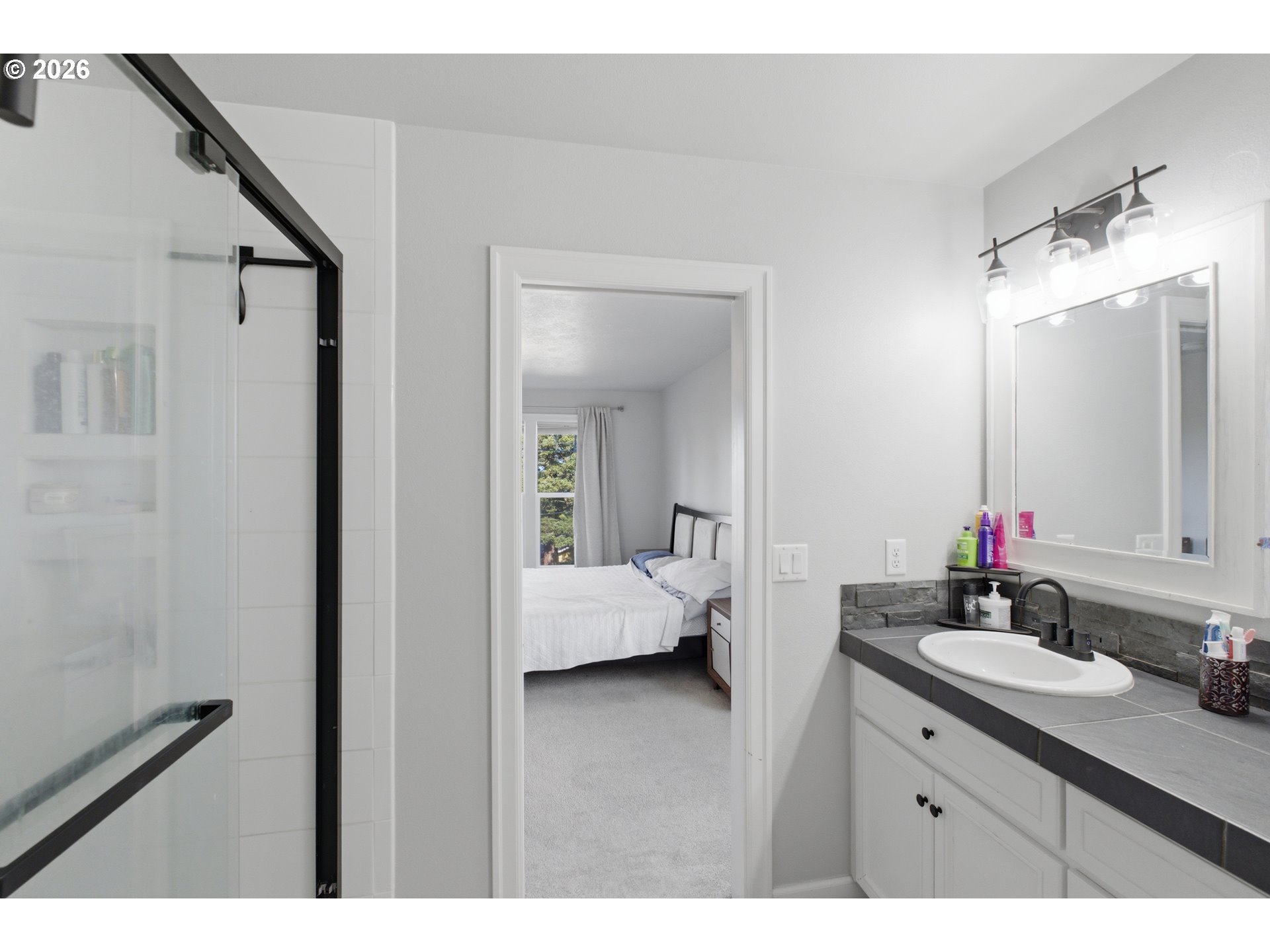 2925 Doaks Ferry Road Northwest Salem, OR 97304 - Photo 33 of 47 a en suite bathroom with a sink and mirror