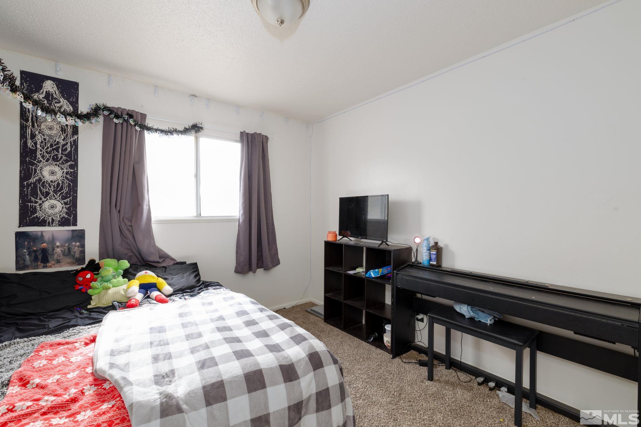 2400 Apollo Way Reno, NV 89503 - Photo 20 of 30 a bedroom with a bed and a window