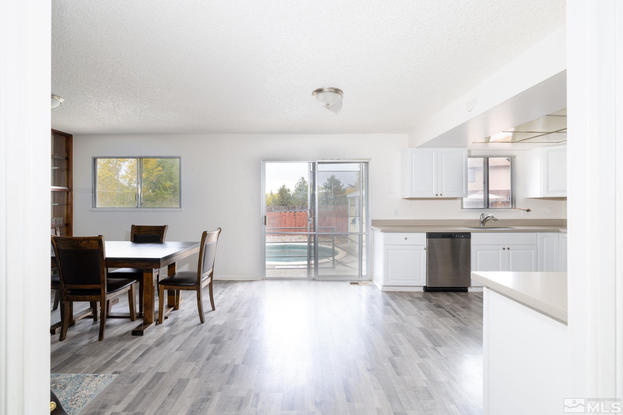 2400 Apollo Way Reno, NV 89503 - Photo 8 of 30 a view of a dining room with furniture and wooden floor
