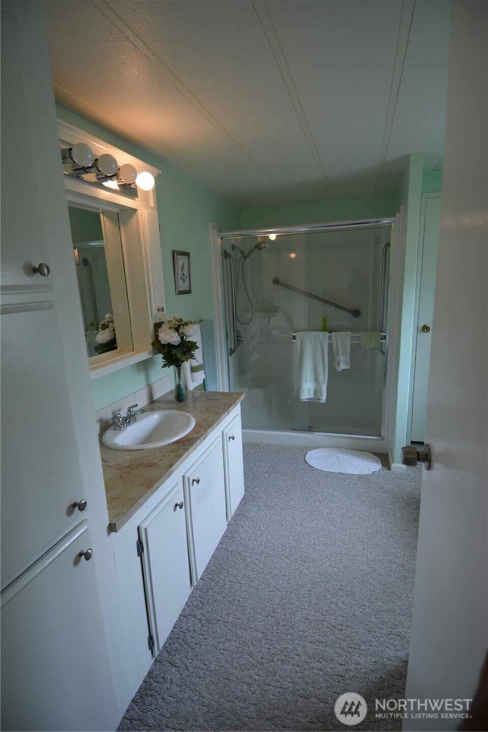 20 Brett Circle Sequim, WA 98382 - Photo 15 of 36 a bathroom with a granite countertop sink mirror and a shower