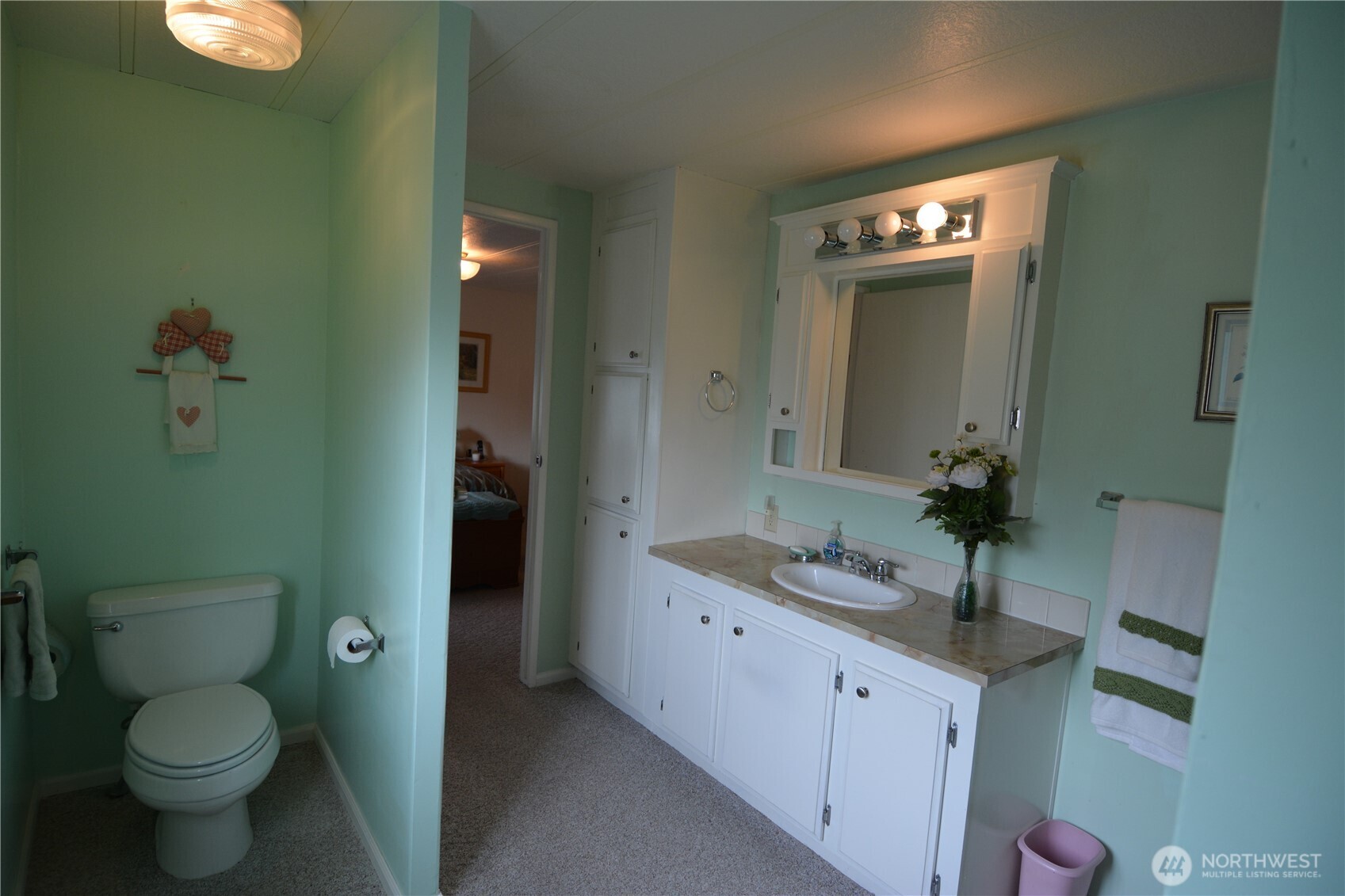 20 Brett Circle Sequim, WA 98382 - Photo 16 of 36 a bathroom with a granite countertop sink toilet and a mirror