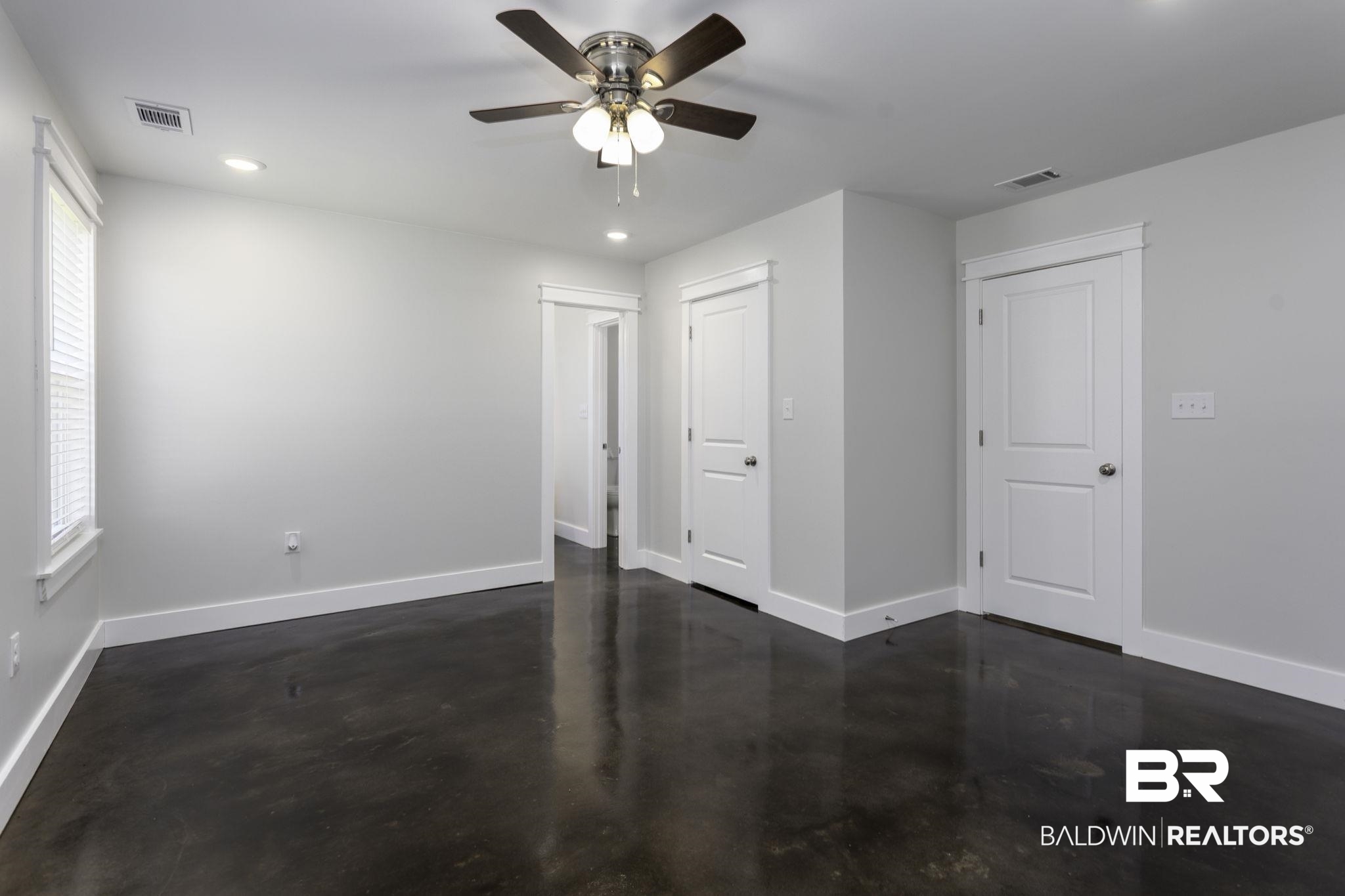 17126 Sugar Loop Foley, AL 36535 - Photo 8 of 28 Empty room with concrete flooring, a ceiling fan, and recessed lighting