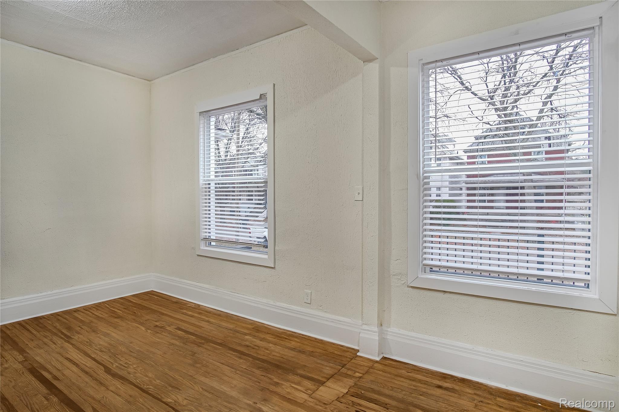 427 Melbourne Street Detroit, MI 48202 - Photo 17 of 29 Unfurnished room with wood finished floors, a textured wall, and a textured ceiling