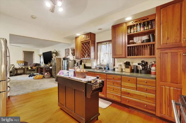 a kitchen with stainless steel appliances granite countertop a stove and cabinets