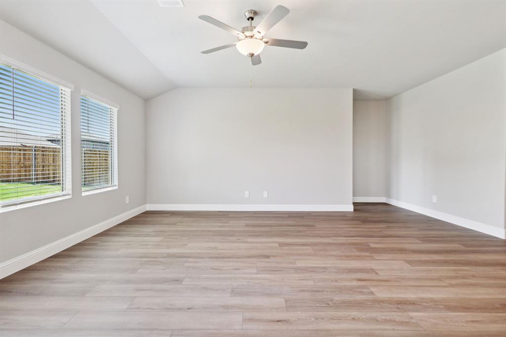 2101 Rannoch Street Sherman, TX 75092 - Photo 12 of 36 a view of an empty room with window and wooden floor