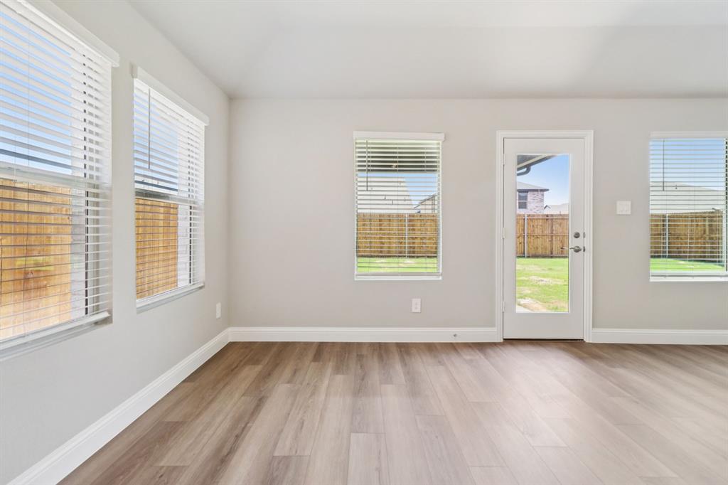 2101 Rannoch Street Sherman, TX 75092 - Photo 14 of 36 an empty room with wooden floor and windows