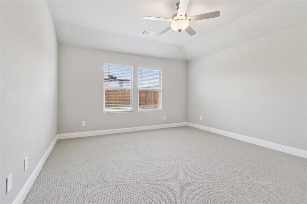 2101 Rannoch Street Sherman, TX 75092 - Photo 17 of 36 an empty room with a window and ceiling fan