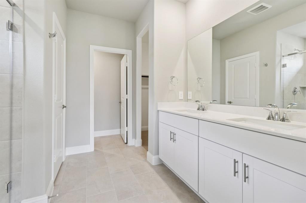 2101 Rannoch Street Sherman, TX 75092 - Photo 22 of 36 a bathroom with double sink and a mirror