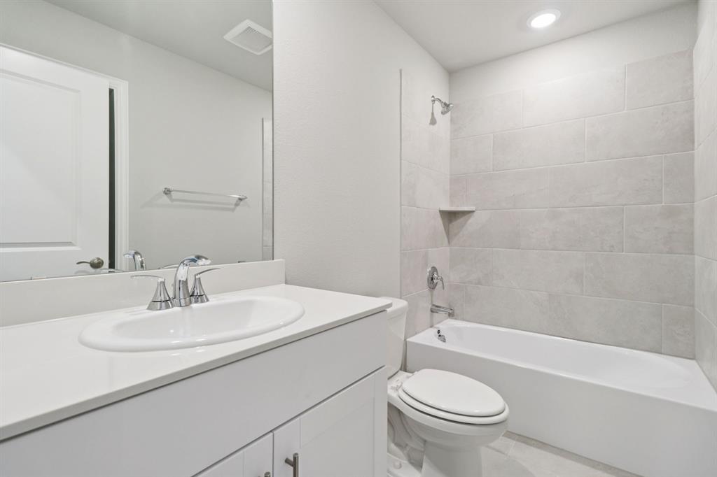 2101 Rannoch Street Sherman, TX 75092 - Photo 33 of 36 a bathroom with a sink a toilet and a mirror