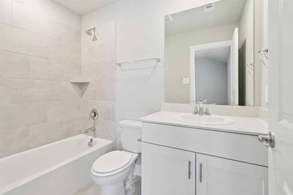 2101 Rannoch Street Sherman, TX 75092 - Photo 34 of 36 a bathroom with a sink toilet vanity and tub