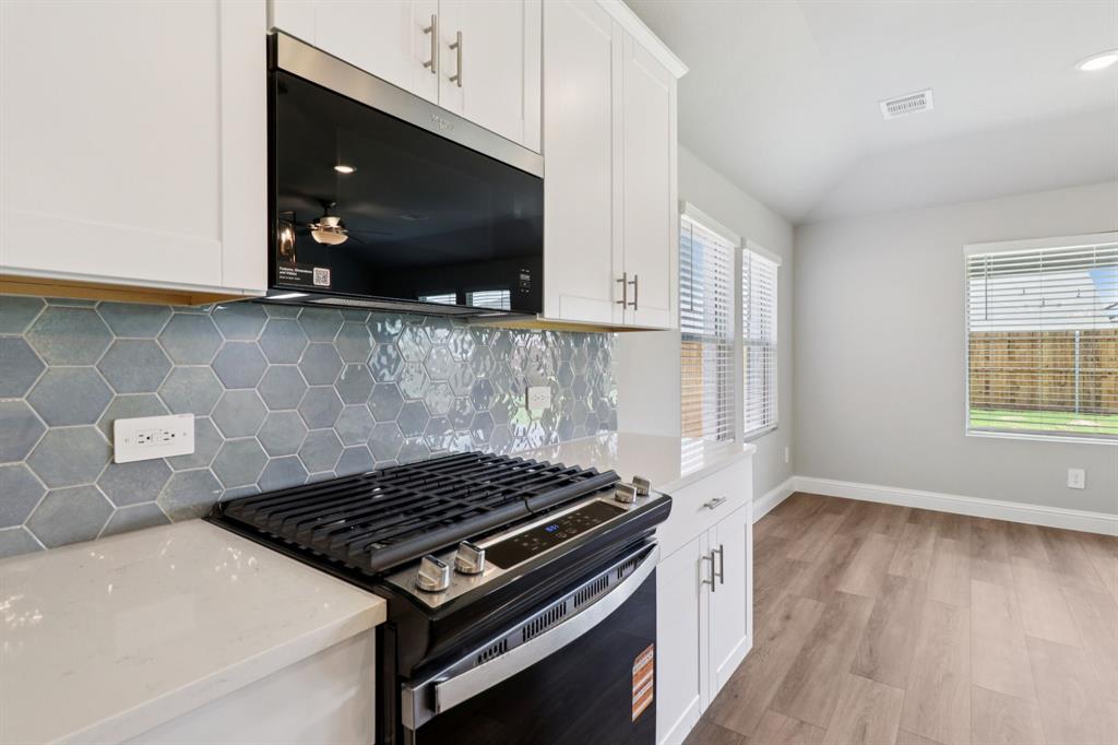 2101 Rannoch Street Sherman, TX 75092 - Photo 6 of 36 a kitchen with a stove and a microwave
