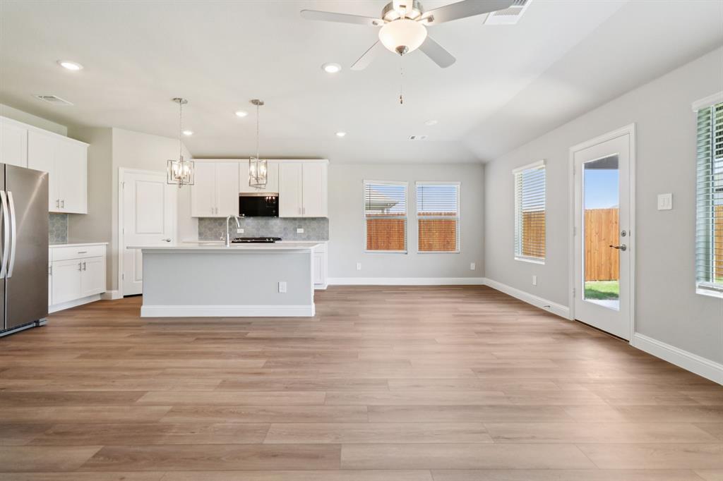 2101 Rannoch Street Sherman, TX 75092 - Photo 7 of 36 a view of a kitchen with a stove cabinets and wooden floor