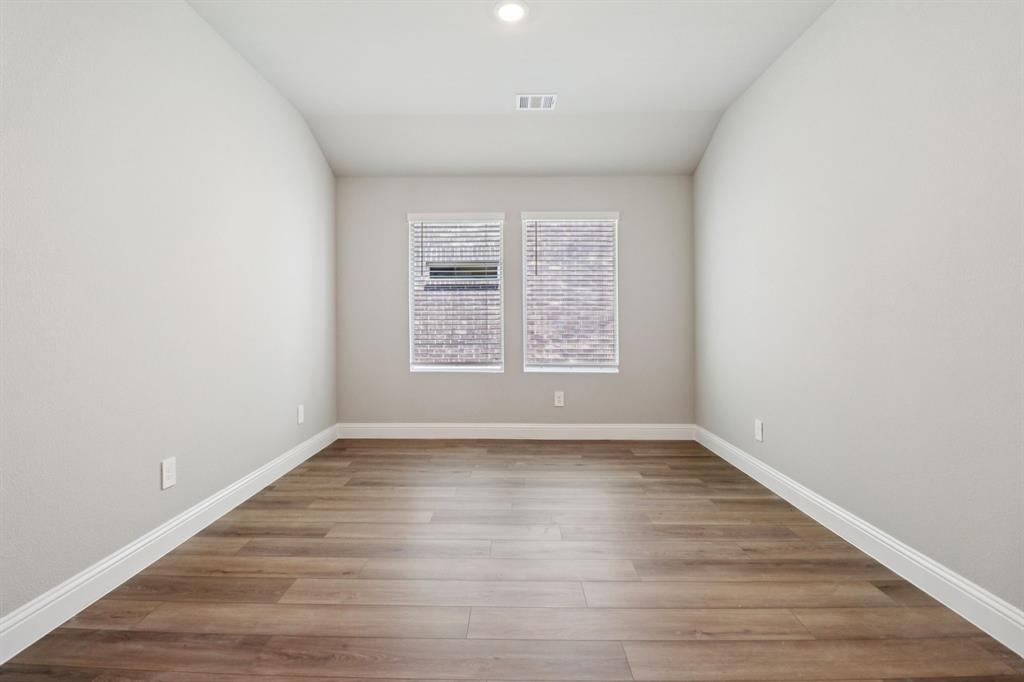 2101 Rannoch Street Sherman, TX 75092 - Photo 9 of 36 an empty room with wooden floor and windows
