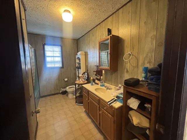 a bathroom with a sink a toilet and mirror