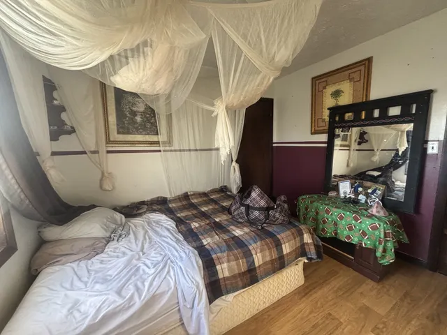 a bedroom with bed and window