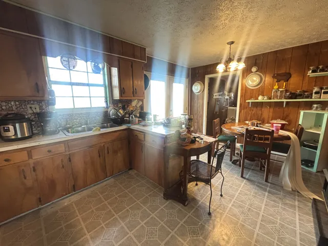 a kitchen with sink and table chair