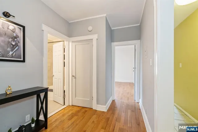 a view of a hallway with wooden floor