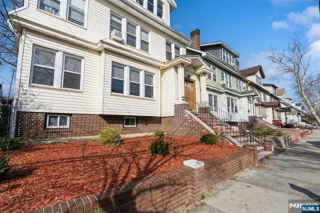 a view of a big house with a yard