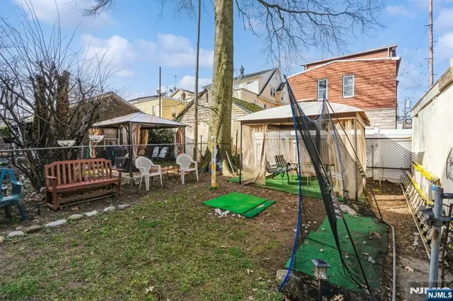 a view of a house with a yard and sitting area