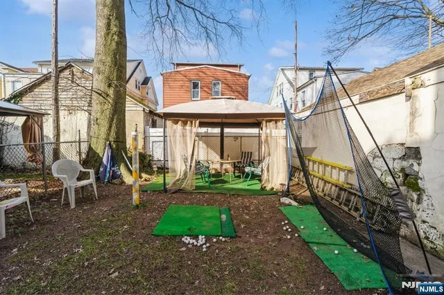 a view of a house with a yard and sitting area