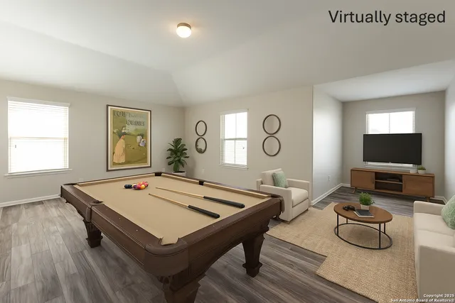 a room with furniture pool table and windows