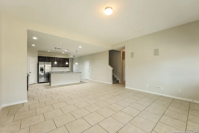 a view of a kitchen with a sink and a refrigerator