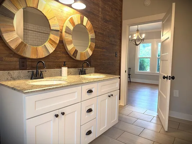 a kitchen with stainless steel appliances granite countertop a sink a stove and cabinets