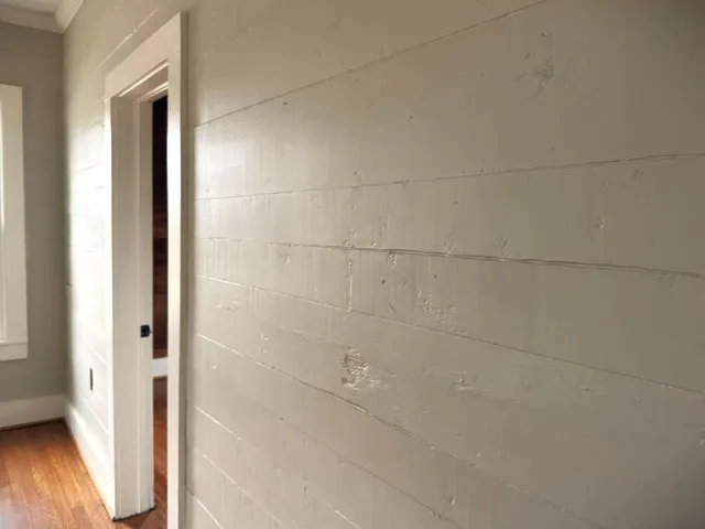 a view of a bathroom with bathtub and wooden floor