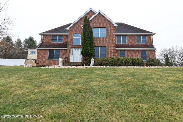 a front view of house with yard and green space