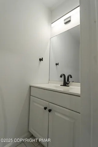 a white toilet sitting next to a white wall