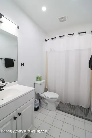 a bathroom with a sink a toilet and mirror