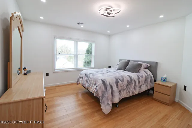 a bedroom with a bed and a dresser