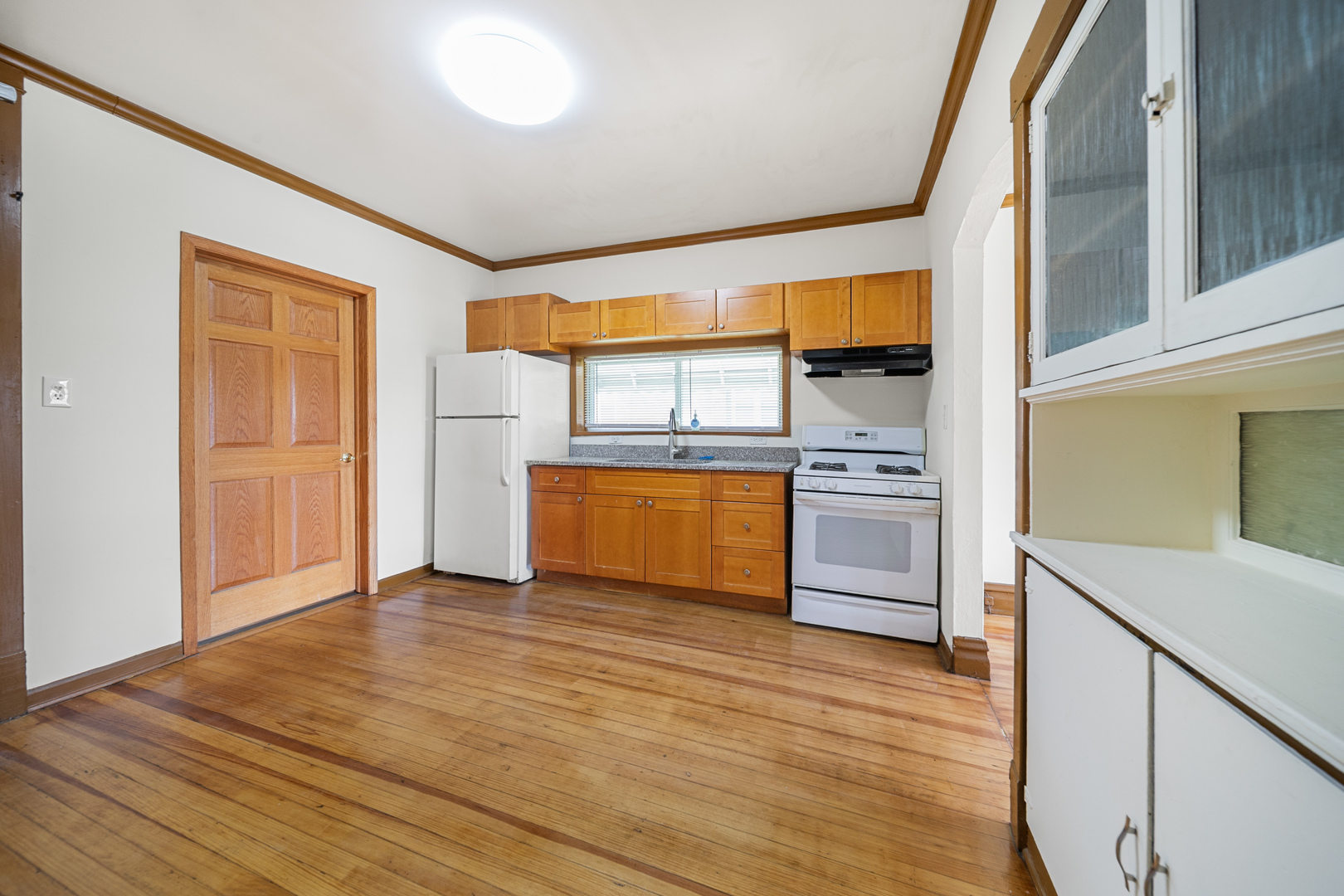 7120 41st Street Stickney, IL 60402 - Photo 5 of 13 a kitchen with granite countertop a stove and a refrigerator