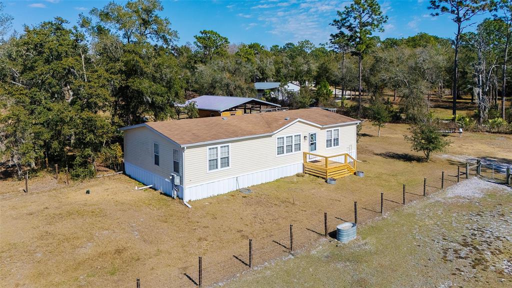 2100 East Kicklighter Road Lake Helen, FL 32744 - Photo 1 of 61 an aerial view of a house with yard and trees