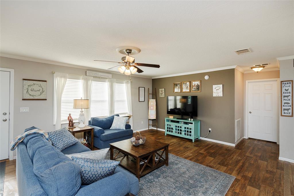 2100 East Kicklighter Road Lake Helen, FL 32744 - Photo 22 of 61 a living room with furniture and wooden floor