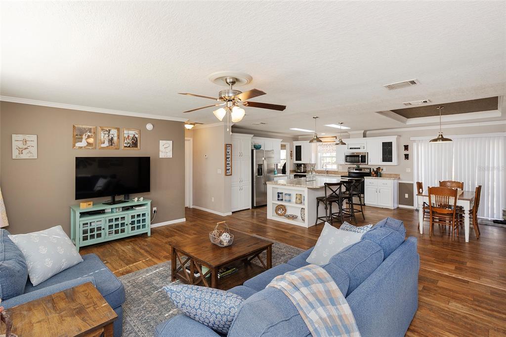 2100 East Kicklighter Road Lake Helen, FL 32744 - Photo 23 of 61 a living room with furniture kitchen view and a flat screen tv