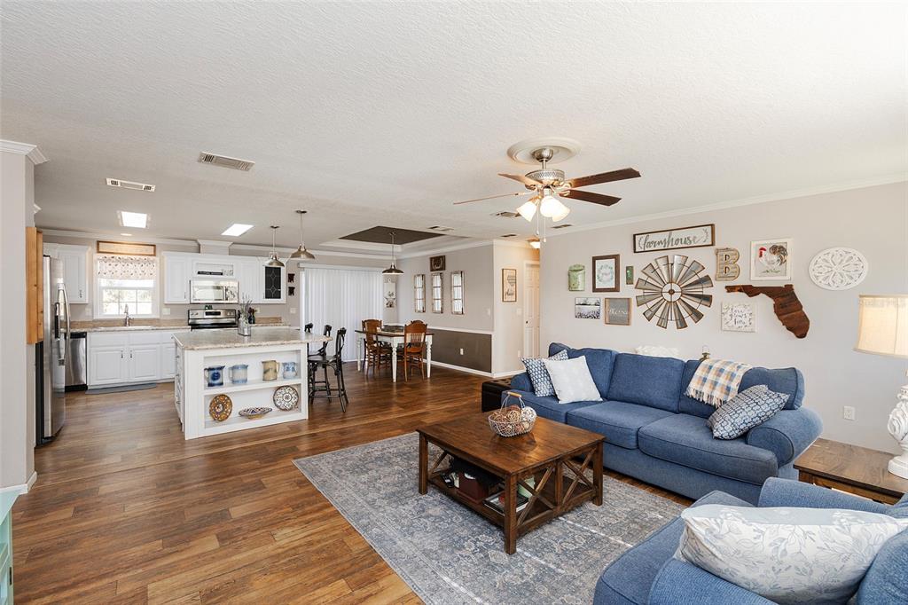 2100 East Kicklighter Road Lake Helen, FL 32744 - Photo 24 of 61 a living room with furniture kitchen and a table