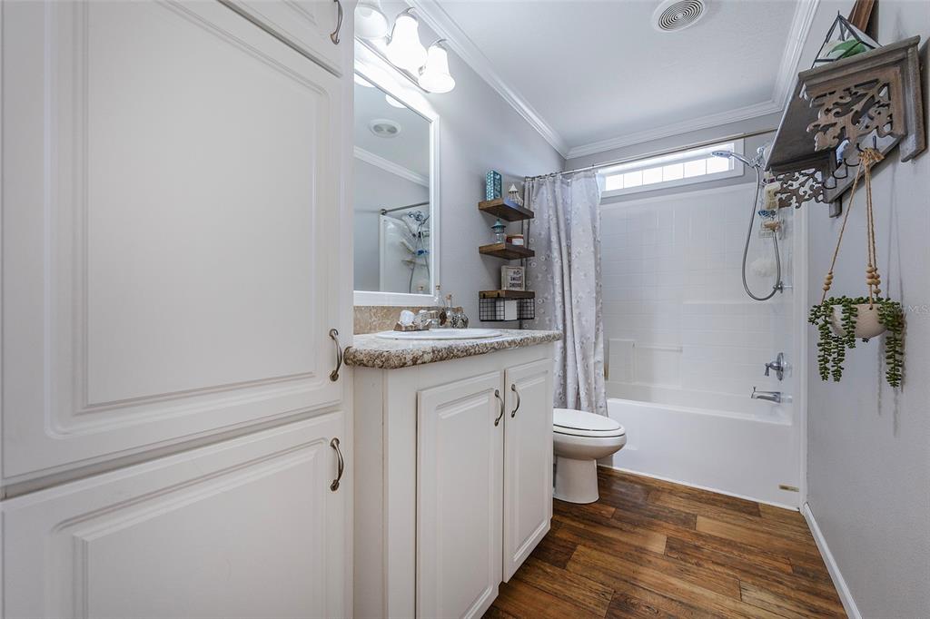 2100 East Kicklighter Road Lake Helen, FL 32744 - Photo 25 of 61 a bathroom with a granite countertop sink a toilet a mirror and shower