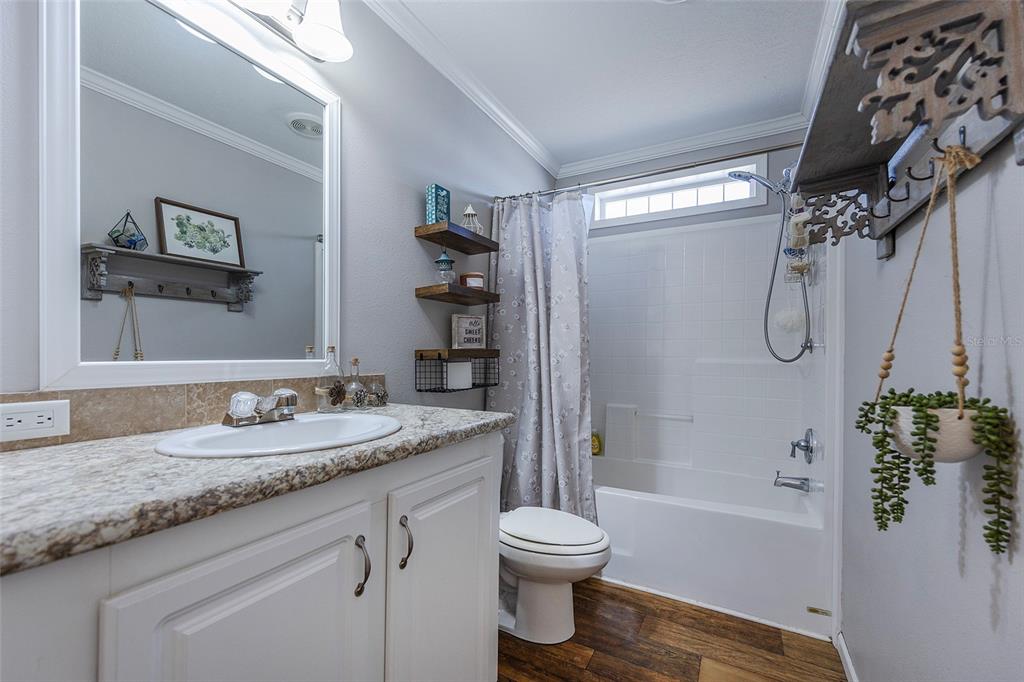 2100 East Kicklighter Road Lake Helen, FL 32744 - Photo 26 of 61 a bathroom with a granite countertop sink toilet and shower