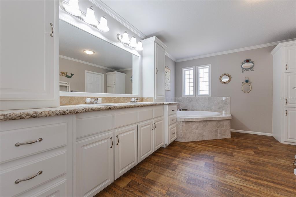 2100 East Kicklighter Road Lake Helen, FL 32744 - Photo 27 of 61 a spacious bathroom with a granite countertop sink mirror and a bathtub