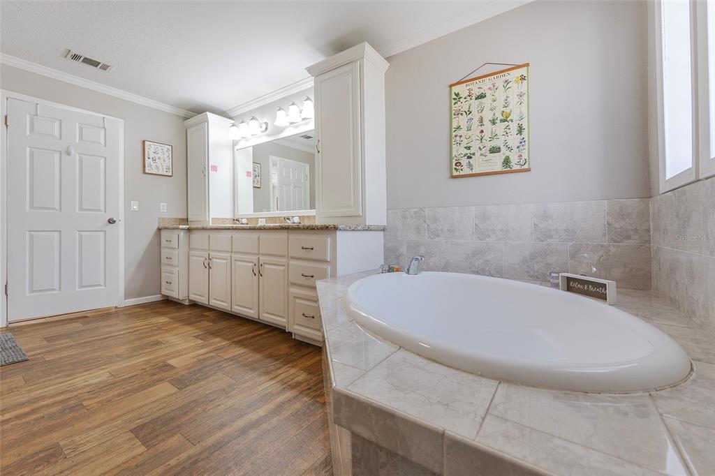 2100 East Kicklighter Road Lake Helen, FL 32744 - Photo 29 of 61 a bathroom with a granite countertop sink a toilet a mirror and window