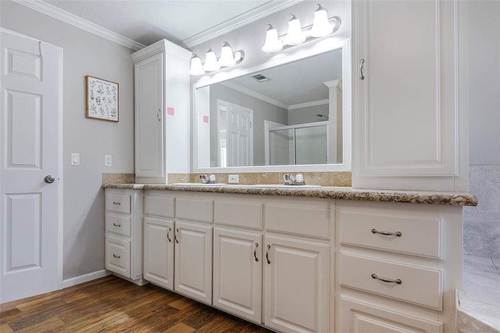 2100 East Kicklighter Road Lake Helen, FL 32744 - Photo 30 of 61 a bathroom with a sink and a mirror